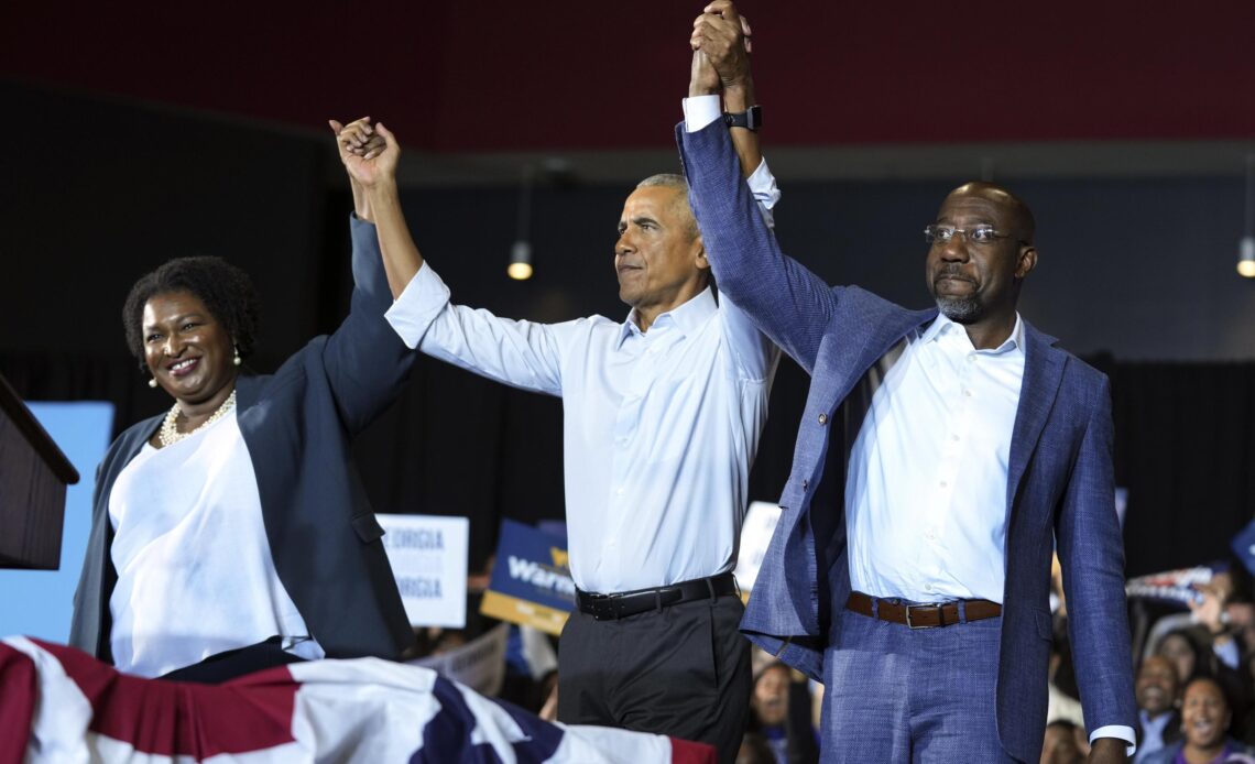 Obama, campaigning in Georgia, warns of threats to democracy