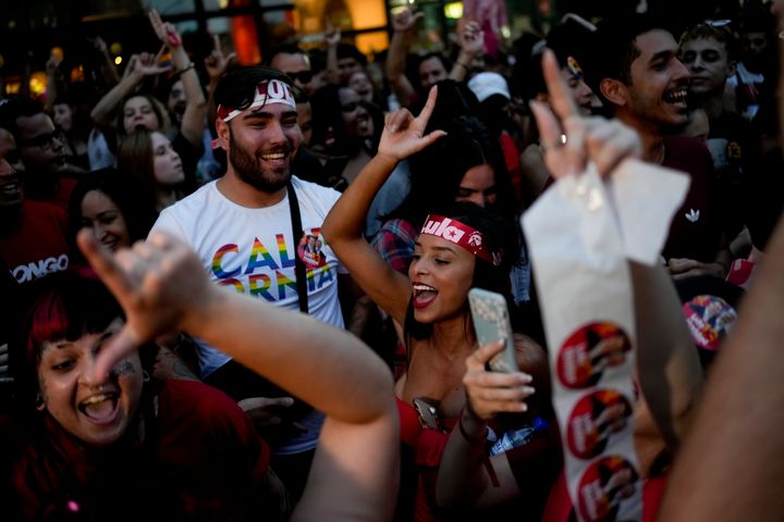 Supporters of Brazil's former President Luiz Inácio Lula da Silva, who is running for president again, dance and cheer as they wait for results after polls closed in the country's presidential run-off election, in Sao Pablo, Brazil, Sunday, Oct. 30, 2022.