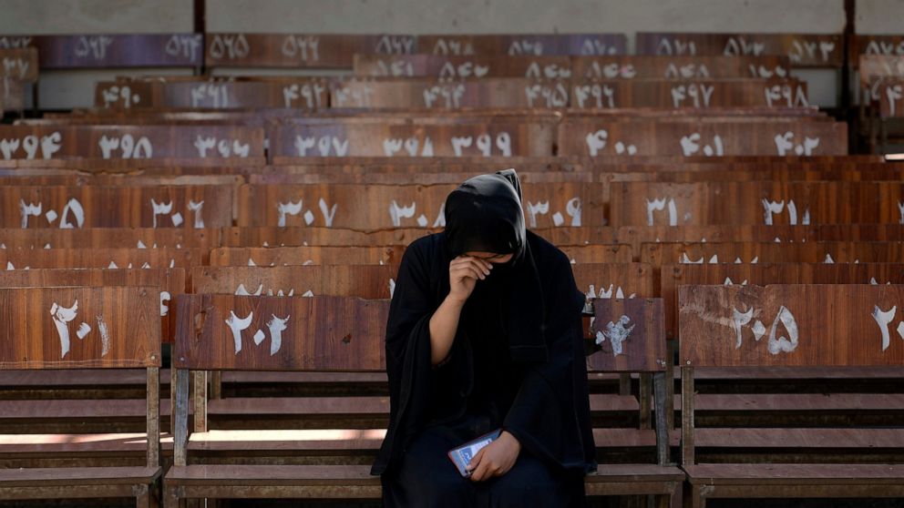 A 19-year old Hazara Afghan girl sits and cries on the bench she was sitting on, during Friday's suicide bomber attack on a Hazara education center, in Kabul, Afghanistan, Saturday, Oct. 1, 2022. Afghanistan's Hazaras, who are mostly Shiite Muslims,