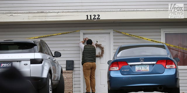 Investigator tapes the door shut at the  house in Moscow, Idaho Tuesday, November 22, 2022, where four people were slain on November 13.