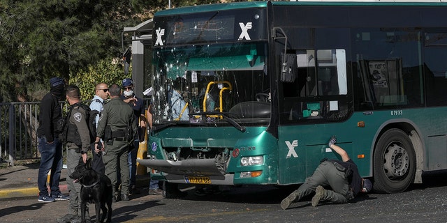 Israeli police inspect the scene of an explosion at a bus stop in Jerusalem, Wednesday, Nov. 23, 2022. Two blasts have gone off near bus stops in Jerusalem, killing one person and injuring at least 14, in what Israeli police said were suspected attacks by Palestinians.