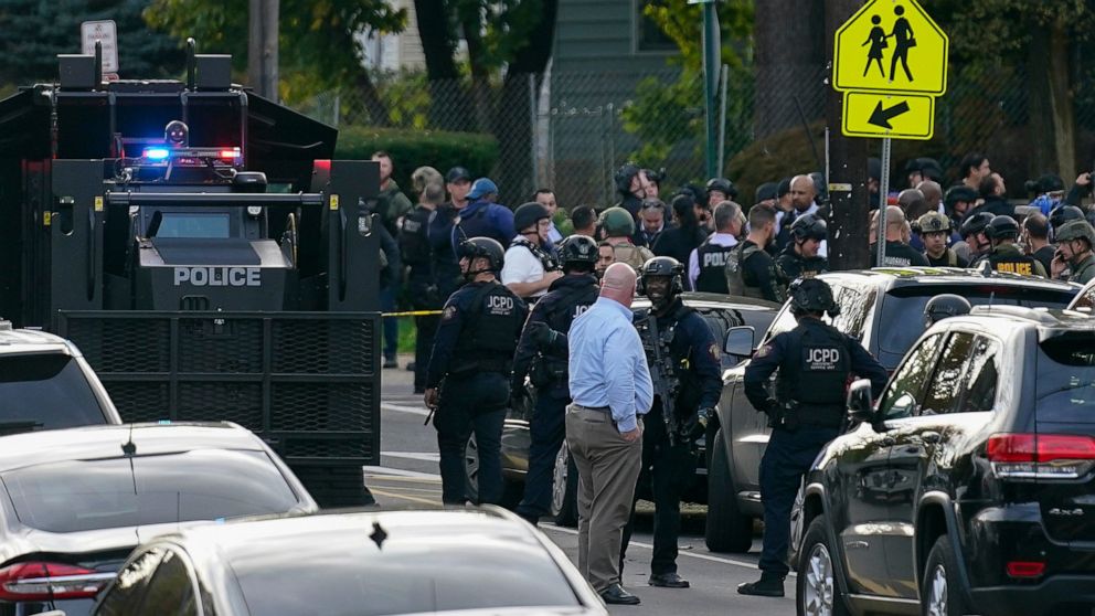 Law enforcement personnel gather at the scene where two officers were reported shot, Tuesday, Nov. 1, 2022, in Newark, N.J. Two officers were being treated for injuries at a nearby hospital, according to the Essex County prosecutor's office. (AP Phot