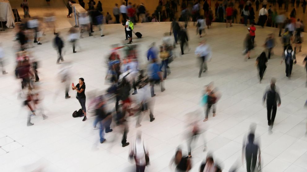 FILE - In this June 15, 2017 photo, people walk inside the Oculus in New York. Google has agreed to a $391.5 million settlement with 40 states in connection with an investigation into how the company tracked users’ locations. State attorneys general