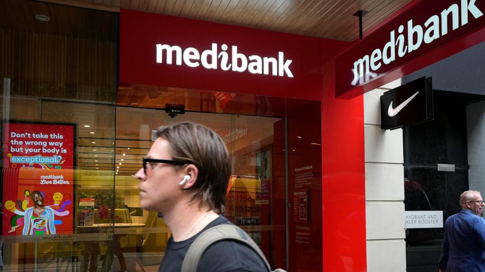 FILE - A man walks past a Medibank branch in Sydney on Oct. 26, 2022. Extortionists have dumped stolen Medibank client records relating medical procedures on the dark web on Thursday, Nov. 10, 2022, in an effort to pressure Australia's largest health