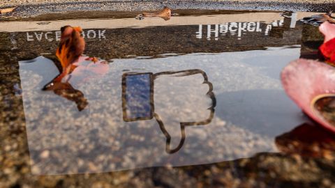 The Facebook logo reflected in a puddle at the company's headquarters in Menlo Park, California, U.S., on Monday, Oct. 25, 2021.