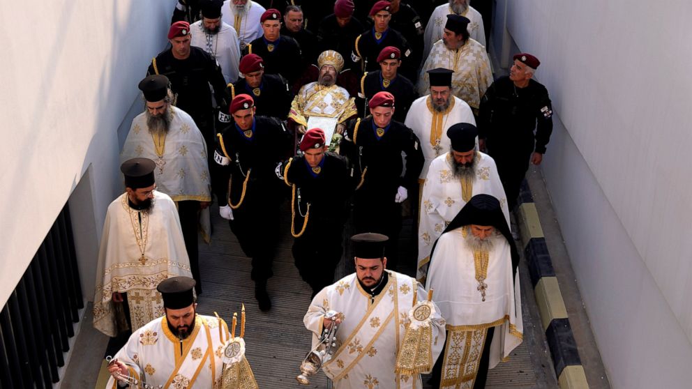 Cypriot soldiers carry the body of the late head of Cyprus' Orthodox Church, Archbishop Chrysostomos II during his funeral ceremony, at Saint Barnabas Cathedral, in Nicosia, Cyprus, Saturday, Nov. 12, 2022. The outspoken Chrysostomos, whose forays in