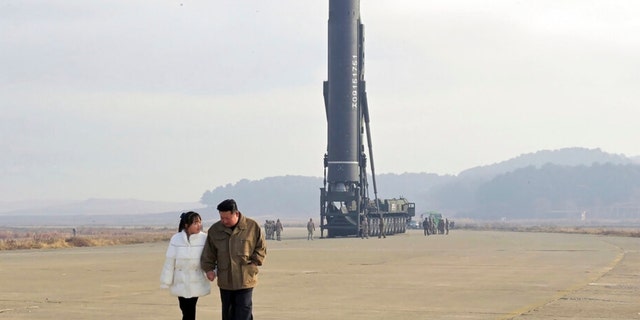 This photo provided by the North Korean government shows Kim Jong Un and his daughter at the site of a missile launch at Pyongyang International Airport in Pyongyang, North Korea, on Friday.