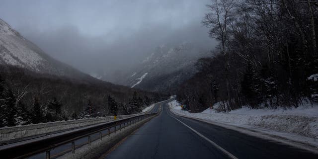 Fog hovers over the narrow road through Franconia Notch on December 27, 2021 in the White Mountain National Forest in New Hampshire.