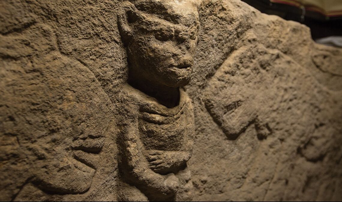 Man holding penis and flanked by leopards is world's oldest narrative carving