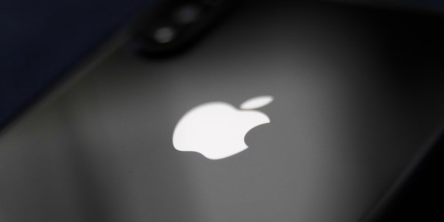 Apple logo is seen on a phone in this illustration photo taken in Poland on Dec. 1, 2020. 