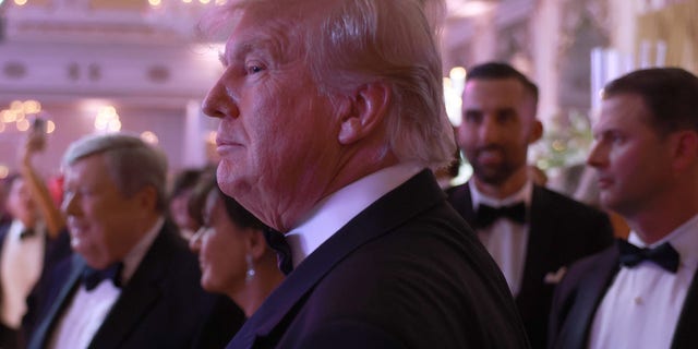 Former President Trump greets people as he arrives for a New Years event at his Mar-a-Lago home on Dec. 31, 2022 in Palm Beach, Florida.