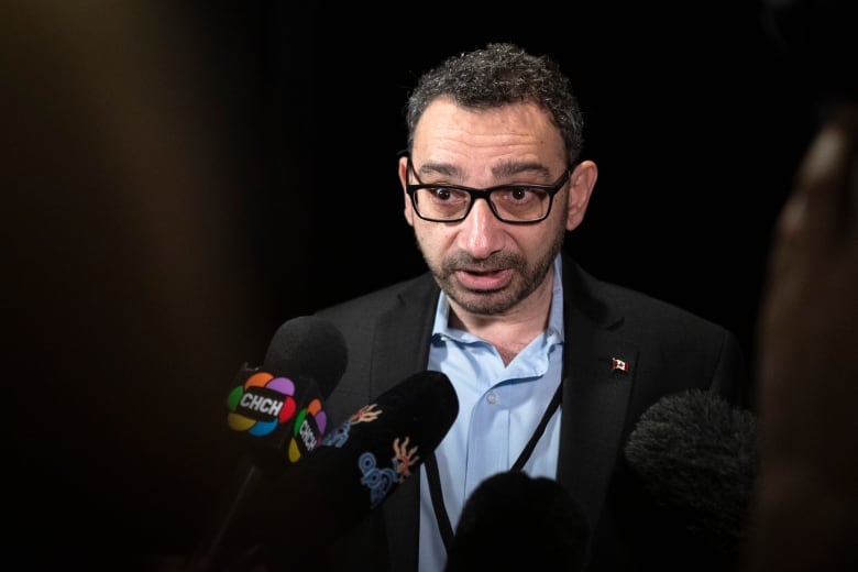 Transport Minister Omar Alghabra is seen speaking to reporters.
