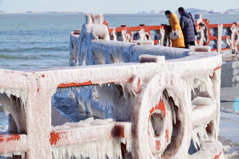 Icicles hang from guardrails along the coast amid a wave of cold weather on Jan. 16, 2023, in Yantai, Shandong Province, China.