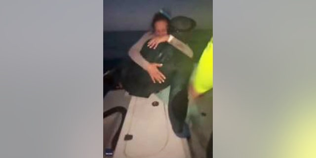 A strong current washed a 22-year-old diver away from his boat. His family pulls him from the chilly water and hugs the man they feared they lost.