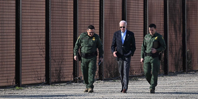 President Biden speaks with members of the U.S. Border Patrol as they walk along the U.S.-Mexico border fence in El Paso, Texas, Jan. 8, 2023. 