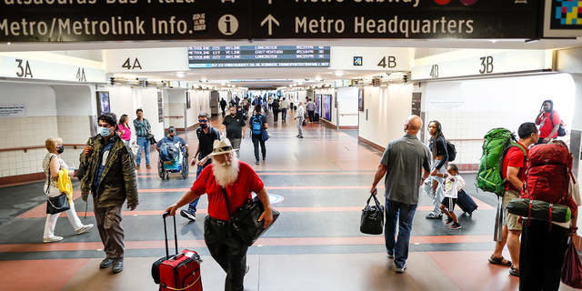 Travelers walk through Union Station in Los Angeles on Aug. 24, 2022.