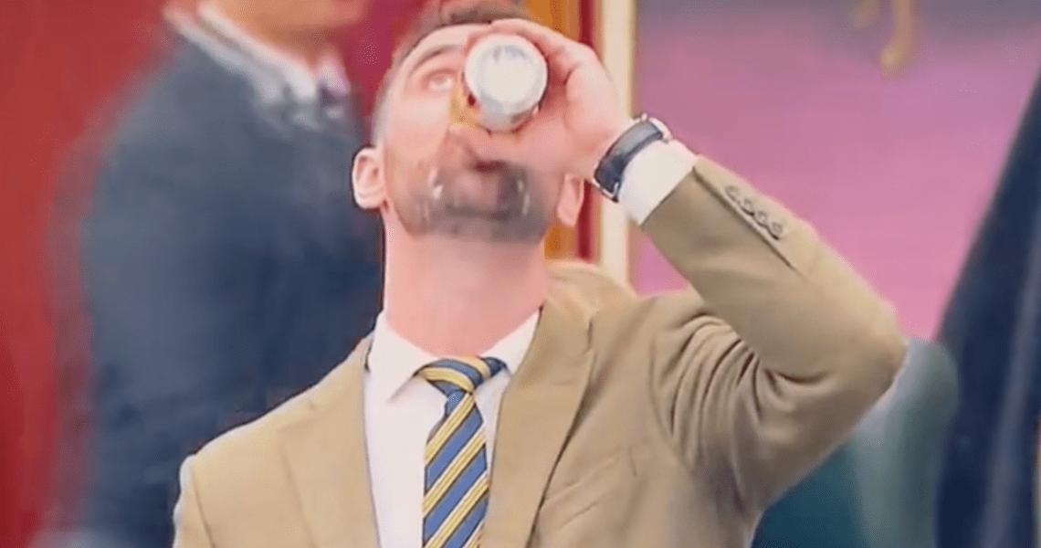 MLA Dan Williams chugs a beer in the Alberta Legislature.