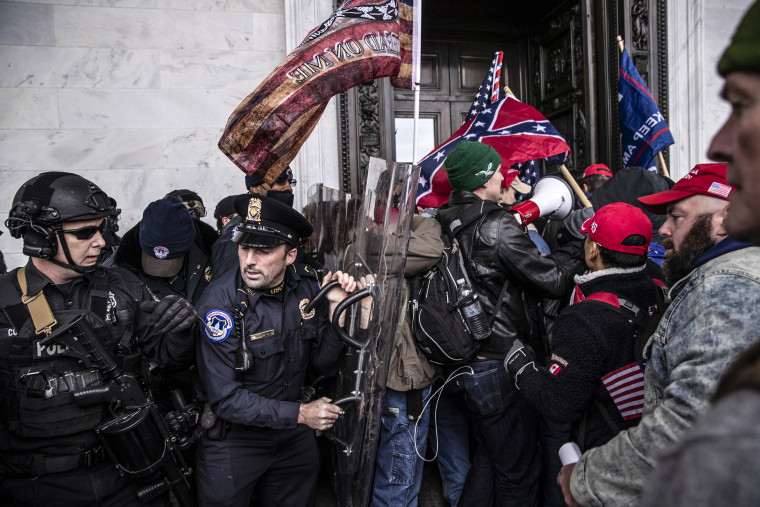 Demonstrators clash with U.S. Capitol police officers while trying to enter the Capitol building during a protest on Jan. 6, 2021.