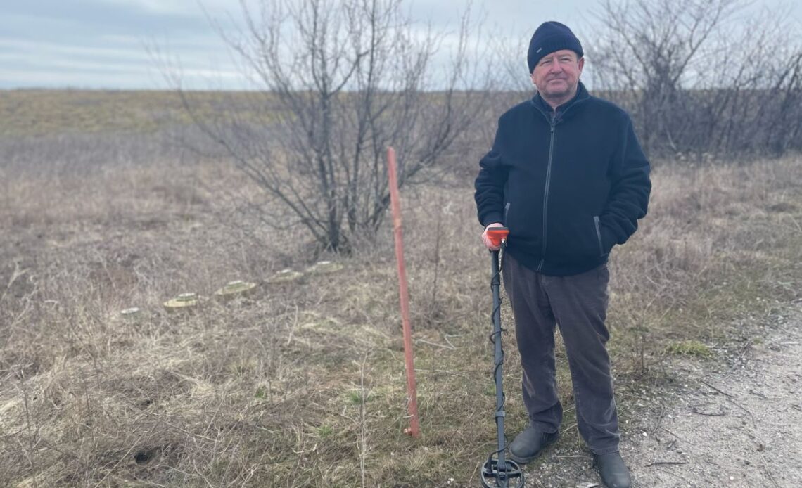 Oleksandr Havriluk with some of the Russian anti-tank mines he dug up in his fields using a metal detector.