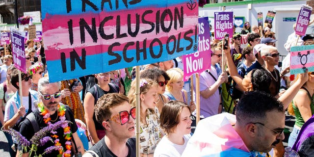 A protester voices support for the promotion of transgender ideology in schools during a march in October 2022.