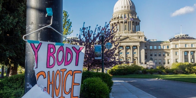 A sign reading "My body, my Choice" hangs from a streetlight in front of the Idaho State Capitol on May 3, 2022.