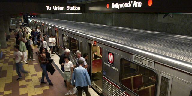 Riders board and depart the Metro Red Line subway train at the Hollywood and Vine station in Hollywood, California.