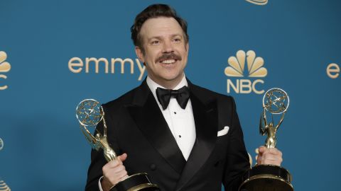 Jason Sudeikis holds his Emmys for