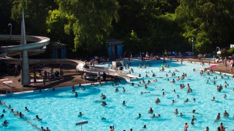 People swim in a public swimming pool in Berlin's Neukoelln district.