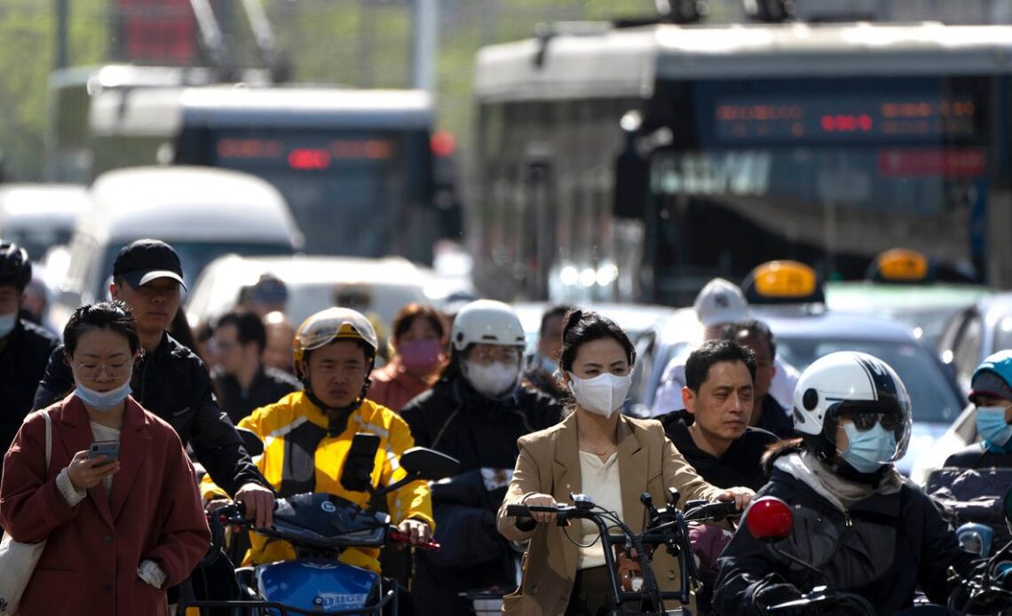 Commuters during Beijing's morning rush hour in April 2023