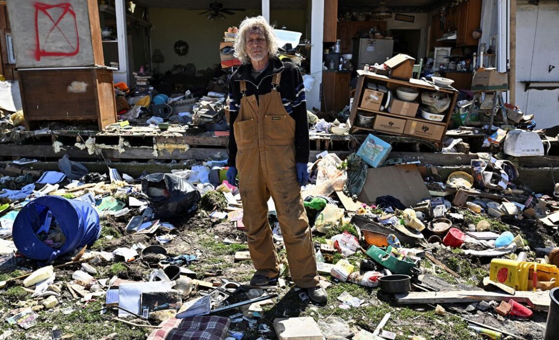 Calvin Cox stands in front of his destroyed home, two days after a tornado hit Sullivan, Indiana on Friday.