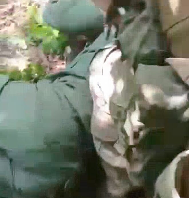 A video that Ukrainian authorities say shows a Russian soldier decapitating a Ukrainian prisoner of war.  (Telegram)