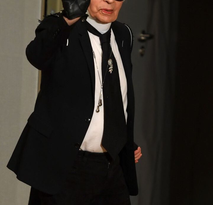 Karl Lagerfeld waves.