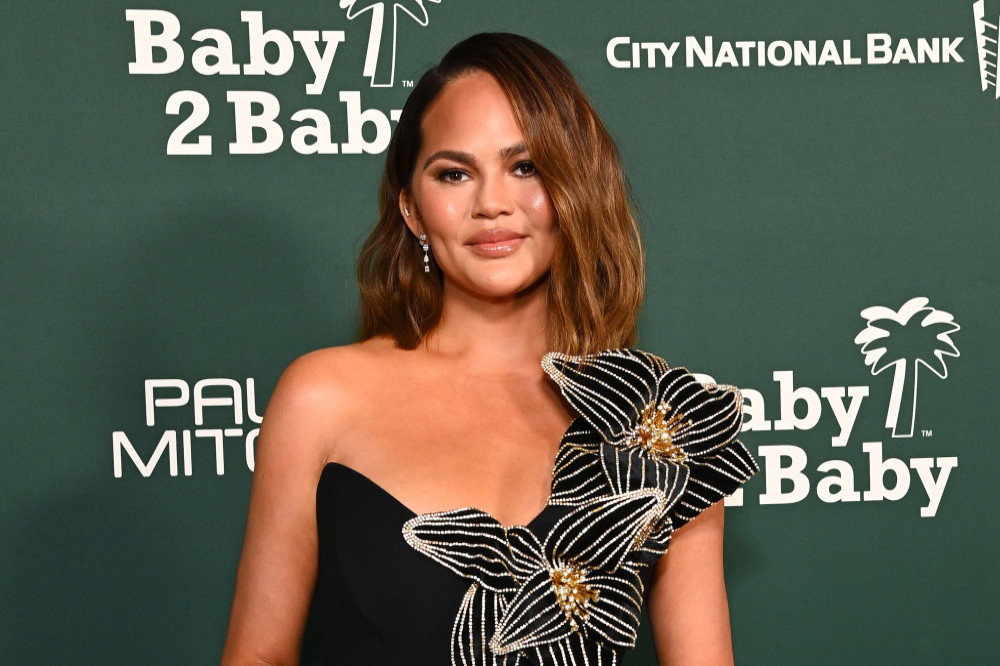 Chrissy Teigen shrugged off an embarrassing wardrobe malfunction that left her exposed