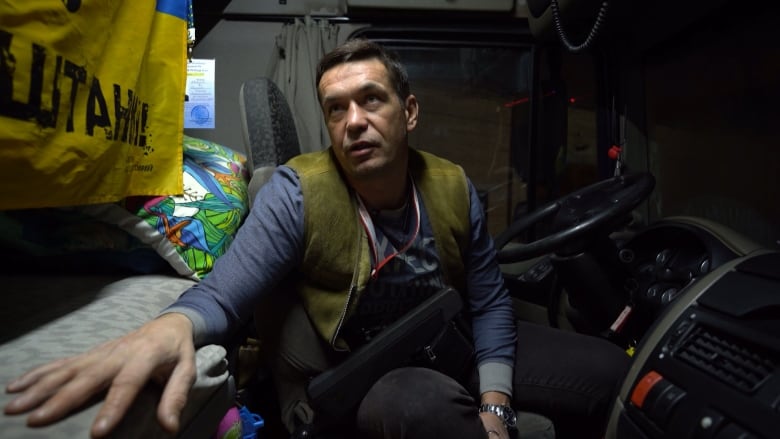 Ukrainian trucker Roman Kaledin speaks to CBC News from the cab of his truck. He was finally able to complete a journey from Kharkiv to central Poland but was stuck at the border for 16 days.
