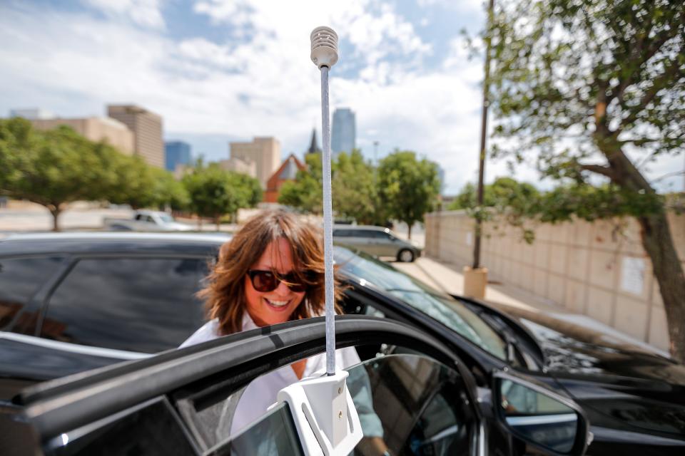 Liz Bowman places a sensor on her car Aug. 12 as planners, scientists and volunteers participated in a federally funded attempt to map the hottest areas of Oklahoma City.