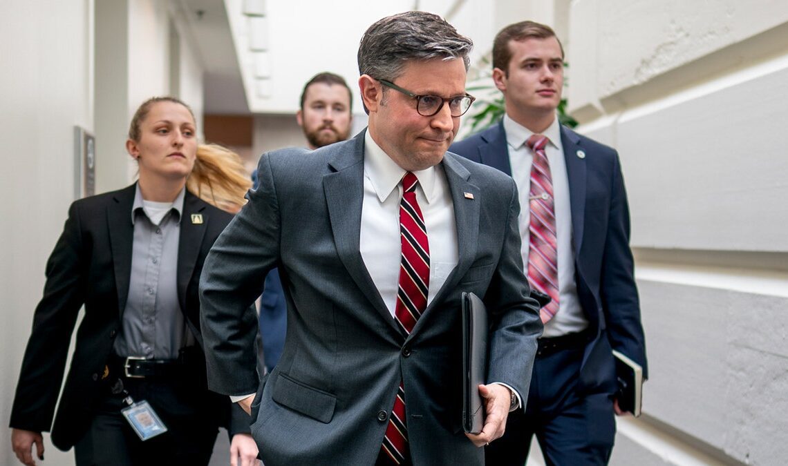 Mike Johnson walking in the Capitol