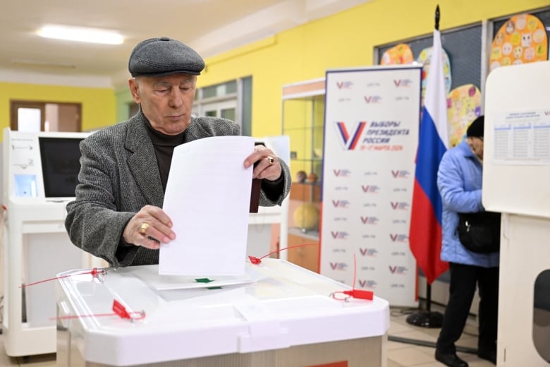 A voter casts a ballot at a polling station.