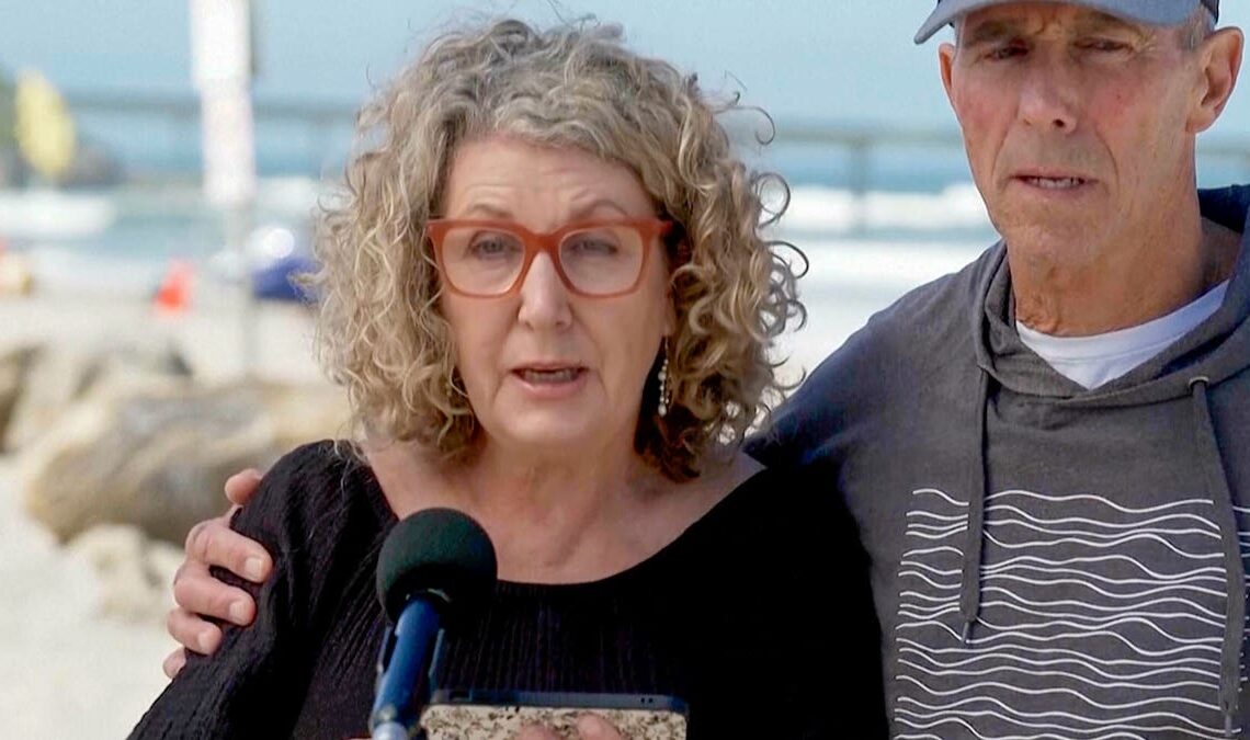 Australia's Debra Robinson with her husband Martin, address the media on the beach in San Diego following the deaths in Mexico of their two sons during a surfing trip.
