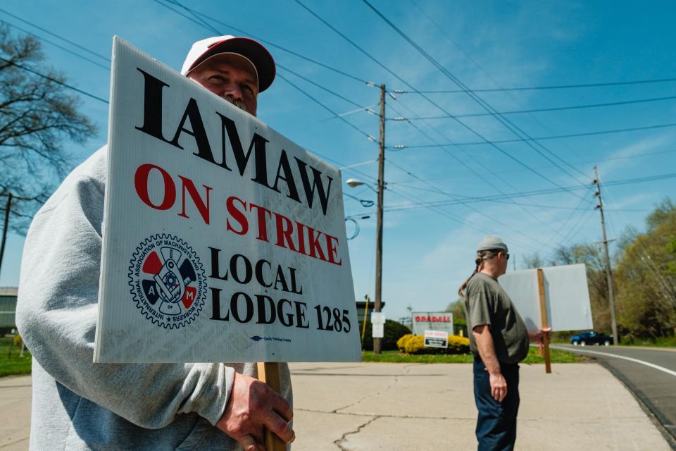 Tommy Gray, left, a Gradall Industries assembler of 29 years stands along with co-worker B. Boffo, a machinist of eight years, on April 15, when members of the International Association of Machinists and Aerospace Workers Local 1285 went on strike.