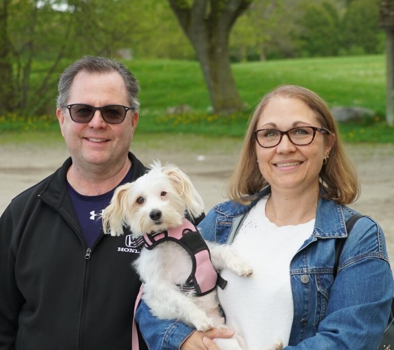 Photo of a couple and their dog.