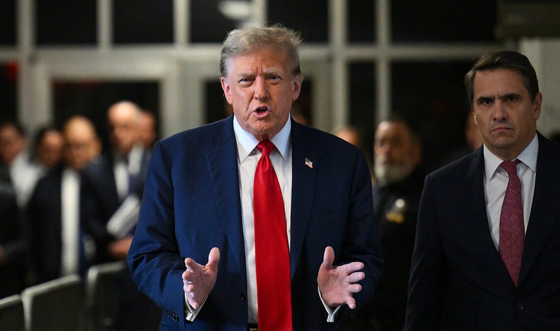former President Trump in red tie, dark coat speaking to press