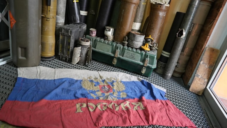 A Russian flag, which is also up for sale, is being used as a doormat in the entrance of Komanda-Ex in central Kyiv.