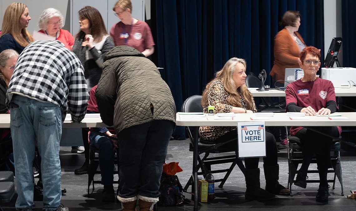 Poll workers help voters at an early voting site on February 17, 2024. in Battle Creek, Michigan. (Photo by Scott Olson/Getty Images)