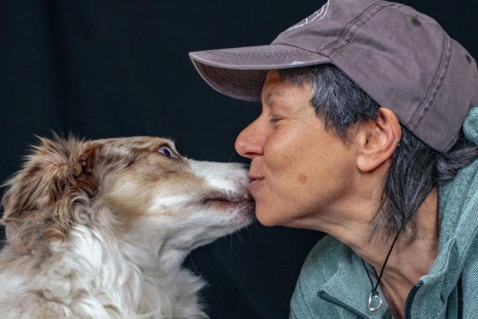 Collie dog Ollie and owner Jacki Gordon, who is wearing a cap