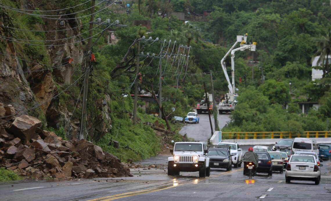 John as a tropical storm hits Mexico's Pacific coast a 2nd time