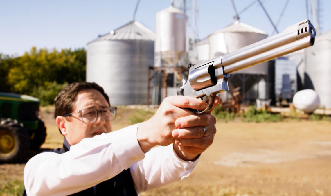 Rep. Mike Flood holding a gun