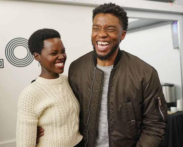 Nyong'o and Boseman in 2018 sharing a laugh at The Apollo Theater in New York City.