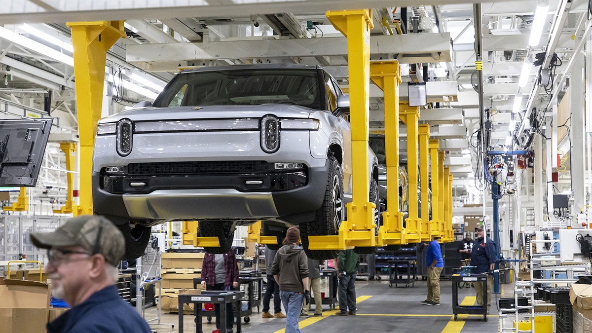 R1T trucks on the assembly line at the Rivian electric vehicle plant on April 11, 2022.