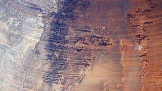 A satellite photo showing massive ridges streaking across the Sahara