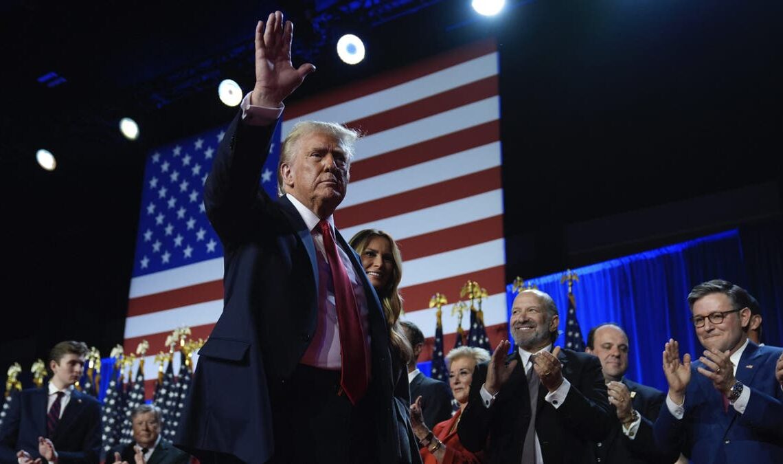 Republican presidential nominee former President Donald Trump and former first lady Melania Trump walk on stage at an election night watch party at the Palm Beach Convention Center, Wednesday, Nov. 6, 2024, in West Palm Beach, Fla. (AP Photo/Evan Vucci)